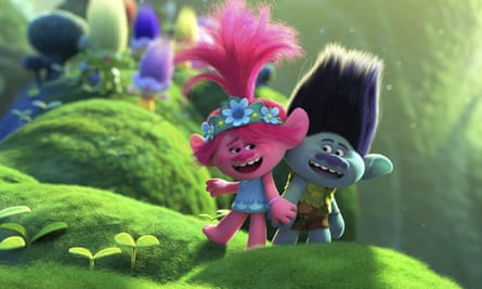 Two of the animated characters from Trolls World Tour in a plant-filled landscape