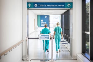 Nurses walk into the Covid-19 vaccination wing of Gold Coast University Hospital on Monday.