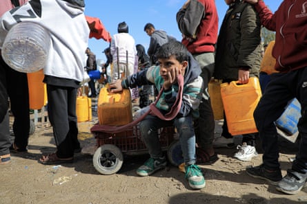 A boy waits in a queue for water in the southern Gaza Strip city of Rafah.