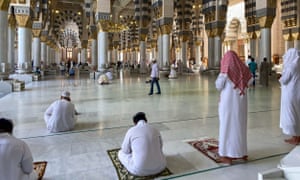 Muslim worshippers perform noon prayer at the Prophet Mohammed’s mosque in Saudi Arabia’s holy city of Medina.