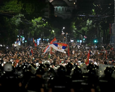 Protesters confront Serbian riot police as tens of thousands gather in central Belgrade to deliver an "ultimatum" to the populist government, demanding early elections after months of student-led strikes across the country in June.