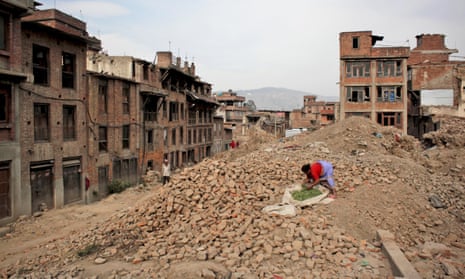 A woman dries vegetables on the rubble of a building damaged in the 2015 earthquake in Nepal. 