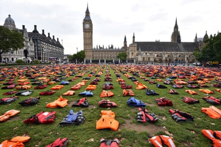 Lifejackets that have been used by refugees to cross the sea to Europe are laid out in Parliament Square in London on 19 September