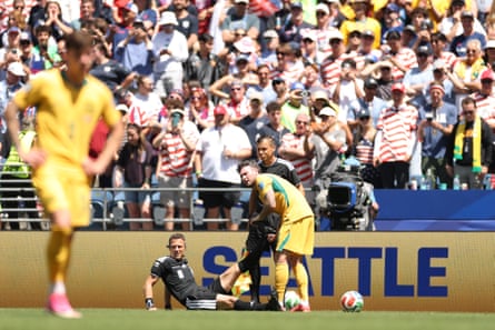 Referee Felix Zwayer gets some help from Australia’s Aiden O’Neill after cramping late in the game.