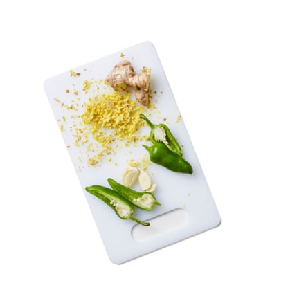 Chopped garlic and chillies on a chopping board.