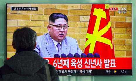A man watches a television news broadcast showing North Korean leader Kim Jong-Un's New Year's speech
