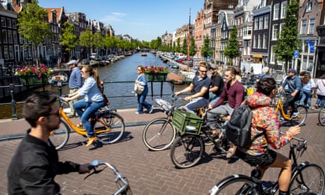 A street packed with cyclists on Amsterdam's Spiegelgracht bridge