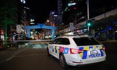 A police car parked beside police tape cordoning off Queen Street