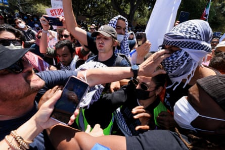 two groups of people facing each other very closely with some people extending their arms