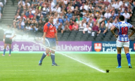 The pitch water sprinklers are accidently activated during the match between the Barbarians and Samoa at the Olympic Stadium.