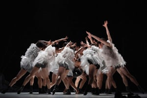 Dancers with bare legs and ruffled plastic sheets over their torsos