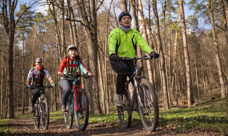 a family group on mountain bikes in woodland