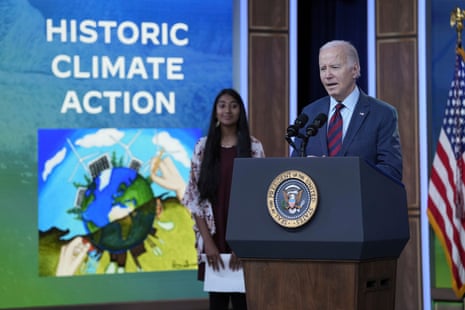 Joe Biden speaks at the White House Tuesday with Ritika Shah, winner of the national climate assessment art climate competition winner.