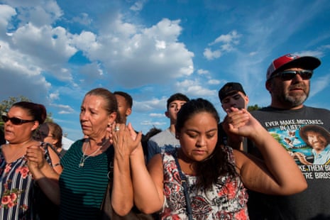 El Pasoans pray at a makeshift memorial for victims of Walmart shooting that left a total of 22 people dead.