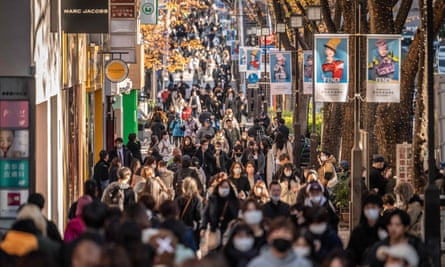 People walk through a shopping street in Omotesando area of Tokyo in December.