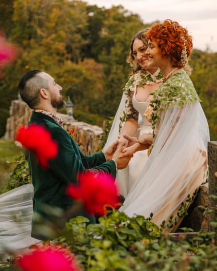 Man and two women hold hands
