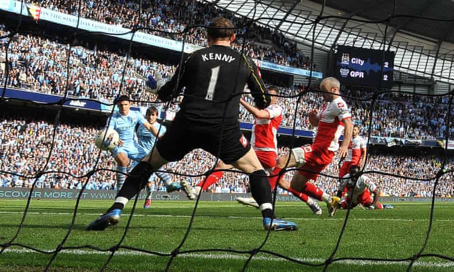 Manchester City’s fires his title-winning goal past QPR’s Paddy Kenny.