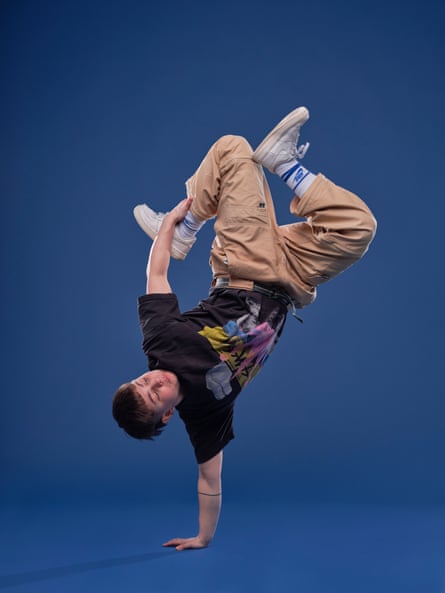 Shortbread balancing upside down on one arm, holding their leg