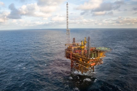 An oil platform in the sea with clouds on the horizon