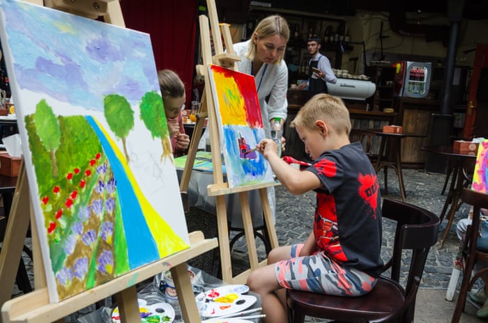 Children who lost their homes and families due to Russian attacks paint pictures for a charity auction in Sligo, Ireland. The proceeds will go towards buying medical supplies for Ukraine.