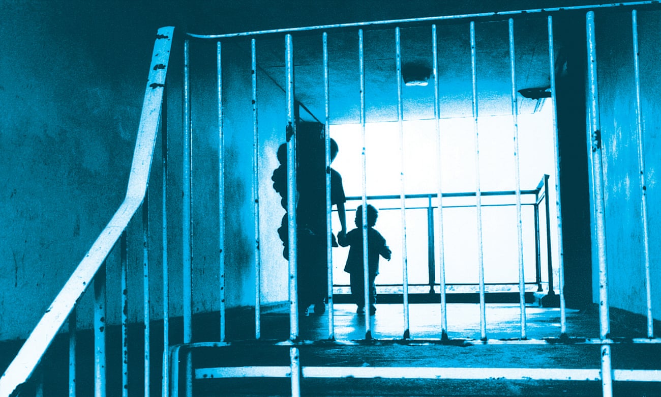 Silhouette of a mother with her children in the hallway of a block of council flats