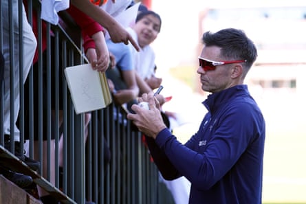 Jimmy Anderson signs autographs at Old Trafford.