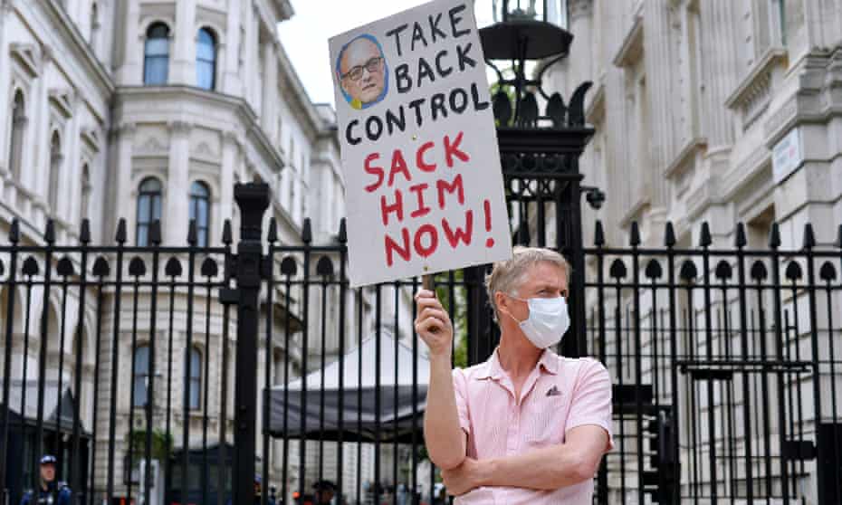 ‘Take back control. Sack him now!’ is the message from one protester outside Downing Street on 27 May 2020.