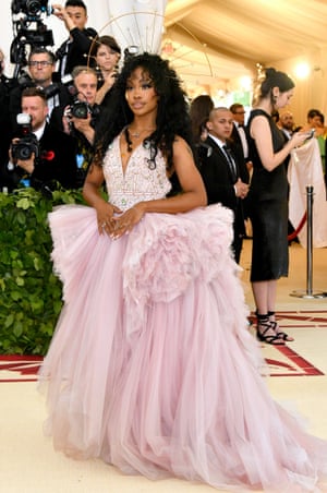 Her frothy pink Versace gown may be light on the religious theme but singer-songwriter SZA topped off the look with a custom halo and bejewelled tear drops.