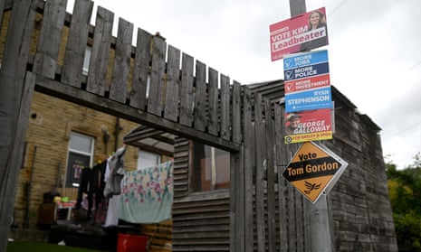 Election posters are displayed on a lamppost ahead of the Batley and Spen byelection