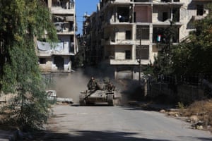 Syrian pro-government forces take part in an operation to take control of Aleppo’s Suleiman al-Halabi neighbourhood, which is divided by the frontline that separates the rebel-held east and regime-held west of the northern city