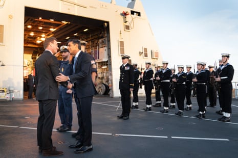 Rishi Sunak shakes Ulf Kristersson's hand as sailors stand in formation behind them on the deck of HMS Diamond