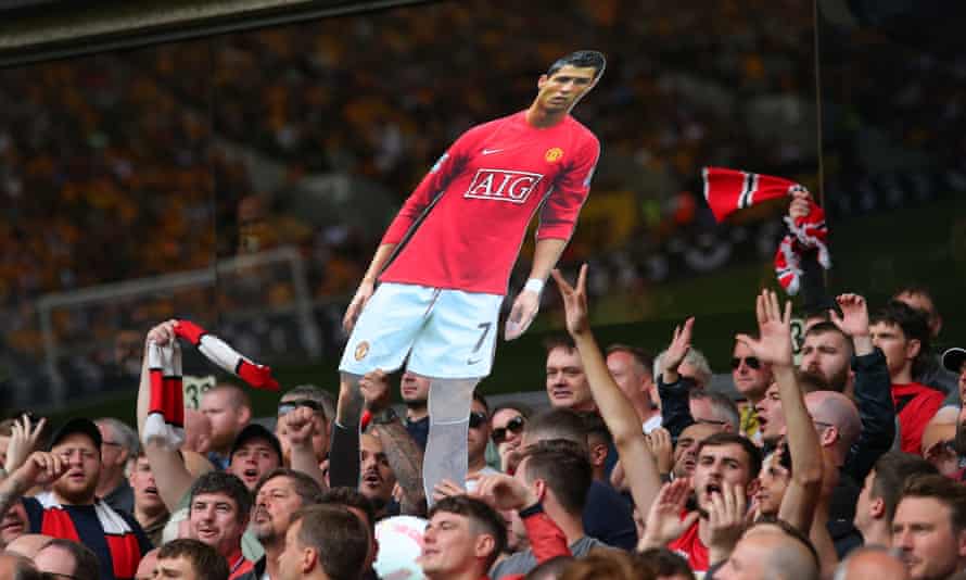 Manchester United fans display a cardboard cutout of Cristiano Ronaldo