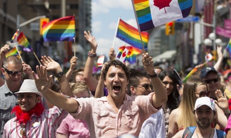 Bassel Mcleash (front right, wearing baseball cap) next to Justin Trudeau at the pride parade in Toronto