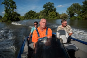 Carmen Hancock (left to right), James Hancock and Rodney Porter boat down a flooded road near their homes in Valley Park, Mississippi on July 16, 2019. They’ve spent the past five months helping their elderly neighbors survive in their homes surrounded by floodwater. “We’re living by the good Lord to do what’s right,” said James. “There’s a number of older people living in this neighborhood, and It’s just the right thing to do. When the going gets tough, the tough gets going. That’s what I live by. You do what has to be done.”