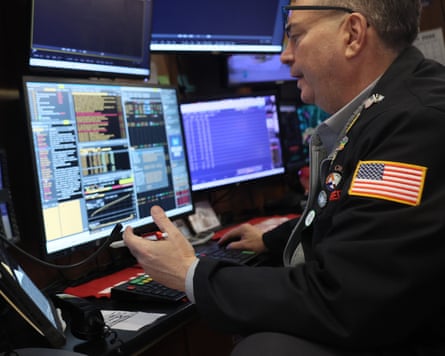 A man sitting in front of a computer screen