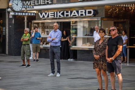 People standing in silence in the street in Graz.