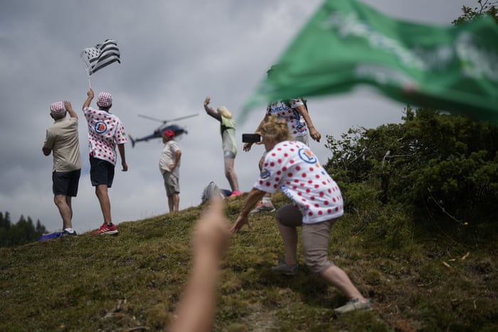 Cycling fans wave to the TV helicopter.