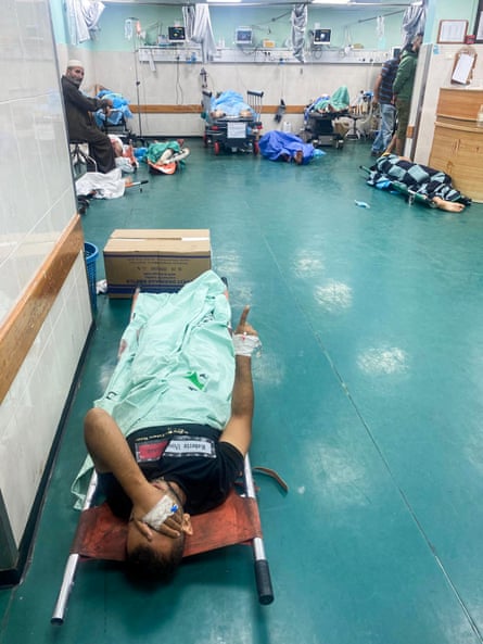 Patients lie on the floor of a hospital