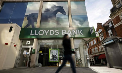 A pedestrian walks past a branch of a Lloyds Bank