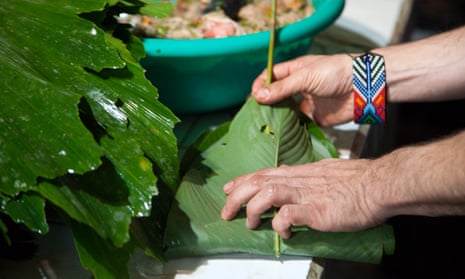 The Colombian chef Eduardo Martínez of the restaurant Mini-Mal wraps fish from the Rio Beni inside of a bijao leaf, to be grilled for a dinner using rainforest products.