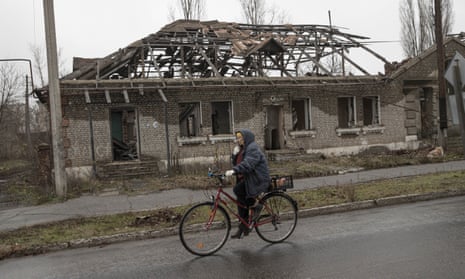 A cyclist passes a ruined building in Lyman, Donetsk Oblast, Ukraine, 27 November 2022. 