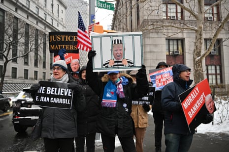 People hold placards outside the Manhattan Federal Courthouse in New York in preparation for the second defamation trial against former US president and 2024 presidential candidate Donald Trump. Former magazine columnist E. Jean Carroll claims that President Trump sexually assaulted her in 1995.