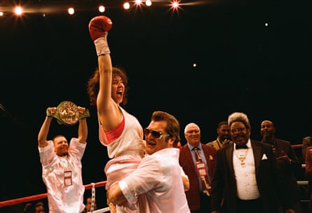 A woman boxer celebrating winning a fight