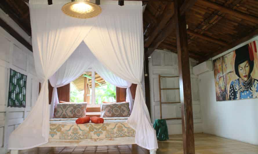 Bungalow and its bed at Janur Bungalow, Borabudur, Indonesia.
