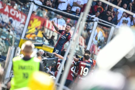 Genoa players celebrate after their late equaliser against Roma