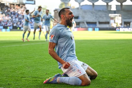 Borja Iglesias celebrates with a knee slide.