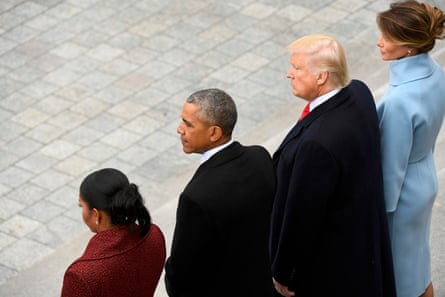 Barack and Michelle Obama stand with Donald Melania Trump