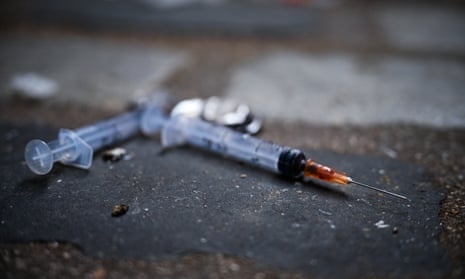  Needles are seen littering the pavement 
