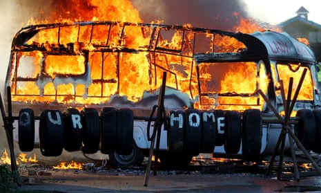 A caravan burning at Dale Farm in Essex on 19 November 2011, as a planned eviction got under way. 
