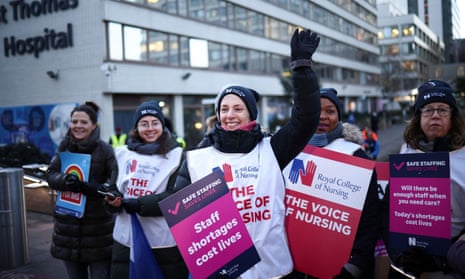 Nurses hold placards in London as strike begins.